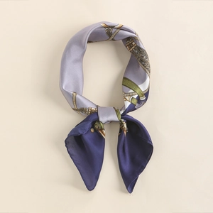 Detail of silk square scarf featuring purple and navy blue panels with golden chain patterns