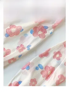 Close-up of floral chiffon sun sleeves showing pink flower patterns and reinforced stitching