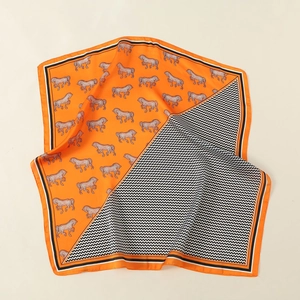 Elegant orange silk square scarf featuring classic horse silhouette and chevron pattern