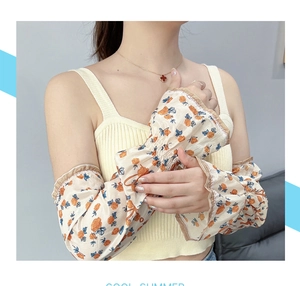 Detailed view of floral chiffon sun sleeves with ruffled cuffs and delicate rose patterns