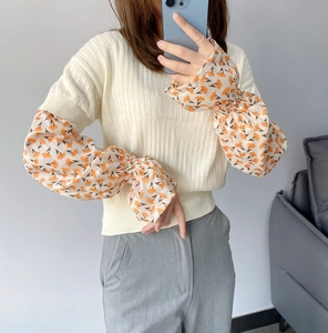 Detail of floral chiffon flare sleeves and ribbed knit fabric for sun protection