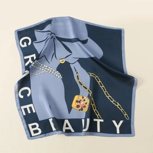 Close-up of vintage silk scarf featuring floral patterns and a fashion lady illustration