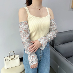 Detailed close-up of floral chiffon sleeves with elastic ruffle cuffs and knit pattern