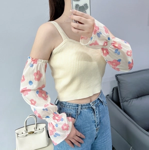Detail of floral chiffon sun protection sleeves with a stylish flared bell cuff design