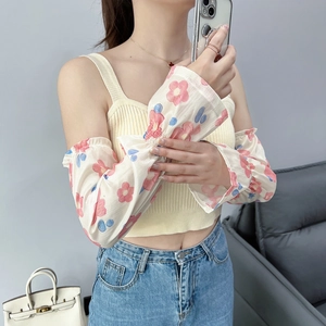 Close-up of floral chiffon sun sleeves with elastic ruffles and red flower patterns