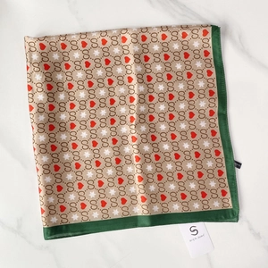 Detailed macro view of the silky square scarf with vintage paisley and heart pattern