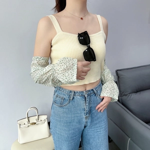 Detail of floral chiffon flared sun sleeves paired with yellow knitted top and denim