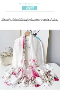 Detail of silk-like scarf with floral print draped over a shirt for an elegant look