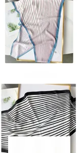Detail of premium striped silk scarves with fine edge stitching and smooth texture