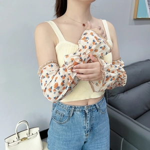 Close-up of floral chiffon sun protection sleeves with ruffled edges and rose pattern