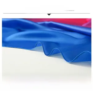 Detail of blue satin scarf showing high-quality hemming process and smooth texture