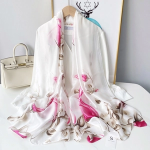 Detailed view of elegant white faux silk scarf with floral print and premium glossy finish