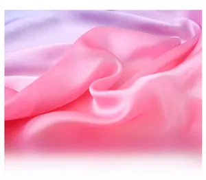 Macro detail of soft pink to lilac gradient satin scarf showing glossy silk texture