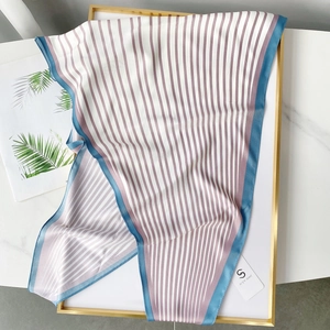 Navy style striped silk scarf with blue, white and pink patterns on a gold frame