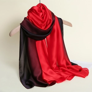 Detail of red and black gradient silk scarf showcasing smooth glossy texture and fine edges