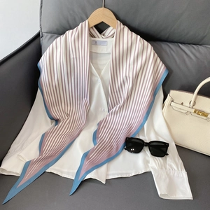 Detail of nautical purple and white striped silk scarf styled on a white cotton shirt