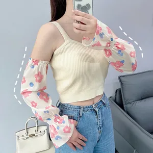 Floral chiffon sun protection sleeves paired with a beige ribbed knit camisole top