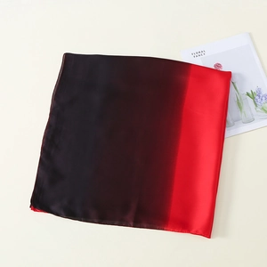 Detail of red and black gradient silk scarf featuring smooth fabric texture and neat edges