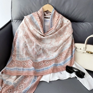 Close-up of ethnic floral pattern scarf styled with a white shirt and a handbag