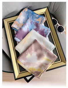Detail of four vintage printed silk scarves with artistic tie-dye marble patterns in gold frame
