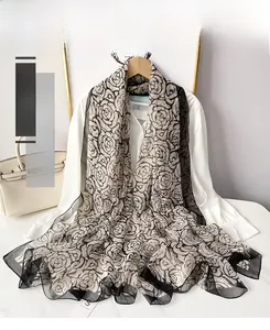 Close-up of semi-transparent silk scarf with vintage black and white rose patterns
