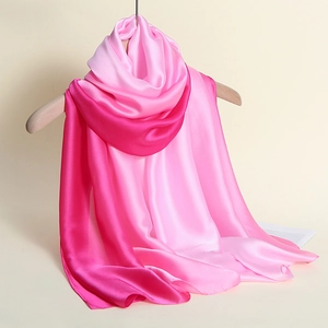 Macro detail of gradient pink satin silk scarf with premium smooth texture and drape