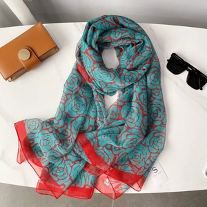 Blue silk-like camellia scarf with red floral patterns for beach and sun protection