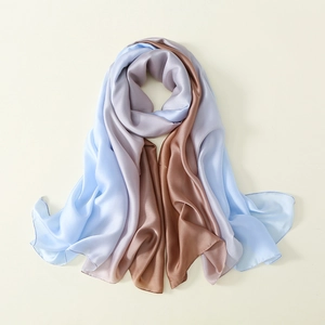 Detail of silk satin scarf showing smooth gradient from light blue to purple and brown