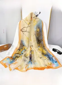 Châle artistique à imprimé floral avec ourlet orange vif et détails en voile léger