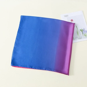 Detail of blue-purple gradient silk scarf on a stylish background with floral magazine