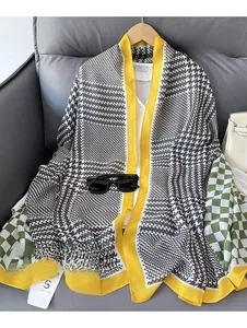 Detail of cotton linen scarf with black houndstooth, green checkerboard, and yellow trim