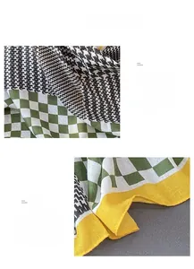 Detail of vintage houndstooth scarf with green plaid pattern and yellow piped edges
