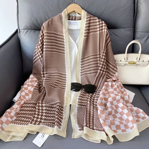 Detail of vintage houndstooth and checkered patterns on a premium cotton linen scarf