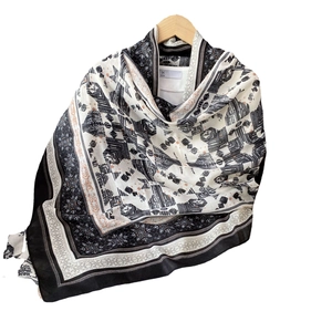 Bohemian black and white cotton linen scarf with ethnic geometric patterns on a wooden hanger