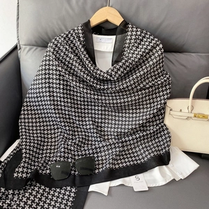 Classic black and white star pattern cotton-linen scarf displayed with accessories