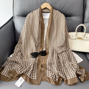 Close-up of brown and white geometric pattern scarf with soft cotton linen texture