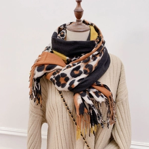 Detail of leopard print patchwork scarf with long fringes and soft cashmere-like texture