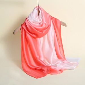 Close-up of peach pink to pearl white gradient silk scarf with a glossy satin finish
