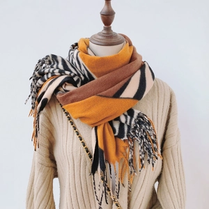 Detail showing zebra pattern print and thick tassels on a warm pashmina scarf