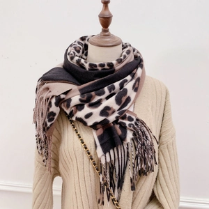 Close-up of leopard print scarf featuring soft knit texture and fringe edge detail