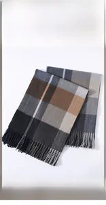 Detailed view of classic plaid scarf with soft fringe tassels in navy and brown tones