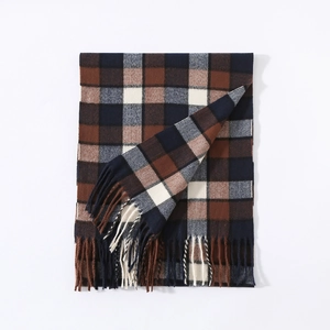 Close-up of classic brown and navy plaid scarf with tassels and thick soft texture