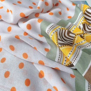 Détail d'écharpe en coton et lin à pois orange avec des motifs géométriques ethniques
