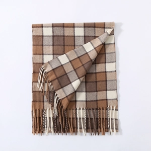 Detailed view of the classic plaid pattern and fringe tassels on winter cashmere scarf