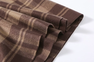 Close-up of brown plaid scarf texture showing soft high-density cashmere-like fabric