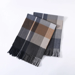 Detailed macro view of classic plaid scarf fabric texture with decorative fringe edges