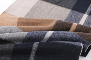 Close-up of soft plaid scarf fabric showing detailed fiber texture and cashmere-like feel