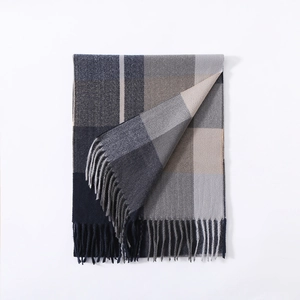 Close-up of grey and blue plaid scarf showing soft cashmere texture and vertical fringe