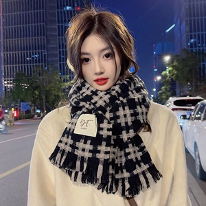 Classic black and beige plaid winter scarf with fringe and a square fabric label on edges
