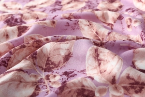 Close-up of lavender square scarf fabric with floral print and soft twill texture